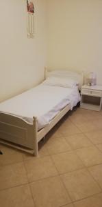 Una cama blanca en una habitación con en Sole e azzurro en Fiumefreddo di Sicilia