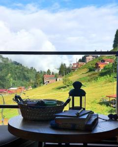 a basket sitting on a table with a view of a field at Ayder Koru Hotel in Ayder Yaylasi