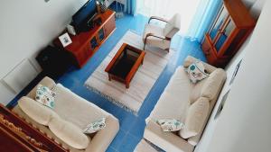 an aerial view of a living room with blue floors at Casa Celia in Nazaré