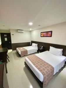 Ένα ή περισσότερα κρεβάτια σε δωμάτιο στο Hotel Acqua Medellín