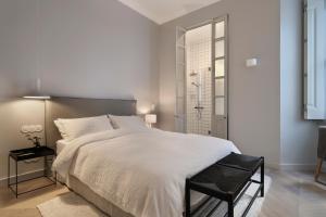 een slaapkamer met een groot wit bed en een douche bij Prime Lisbon - Boavista 44 in Lissabon