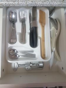 a drawer filled with silver utensils in a drawer at Уютный домик в деревне in Privolzhsk