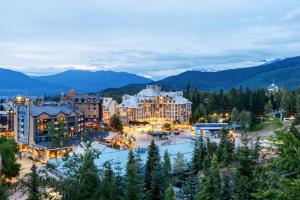 a view of a resort with mountains in the background at Tyndall stone lodge by Cozystay signature Whistler in Whistler