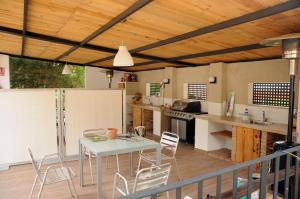 a kitchen with a table and chairs on a deck at Villa Caramel in Villalba de la Sierra
