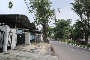 an empty street with a building on the side of the road at Charisma Residence Syariah in Surabaya