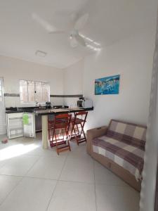 a kitchen with a table and chairs in a room at Villagio Aloha Beach in Bertioga