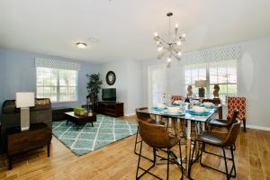 a dining room and living room with a table and chairs at Vista Cay Luxury 4 bedroom condo in Orlando