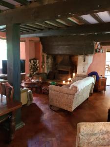 a living room with a couch and a fireplace at Ford House in Stockland