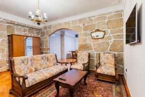 a living room with a stone wall at Riverside City Centre Apartments in Porto