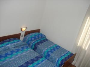 מיטה או מיטות בחדר ב-Albergo Larese