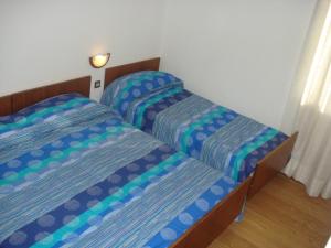 Łóżko lub łóżka w pokoju w obiekcie Albergo Larese
