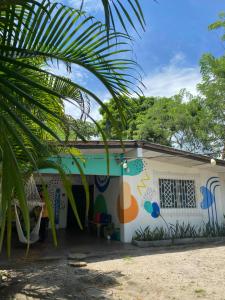 a house with a mural on the side of it at Acuarela Hostal in Playa Blanca