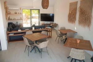 a living room with wooden tables and chairs at Casa Lulú in San José del Cabo