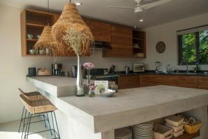 a kitchen with a large island with a counter top at Casa Lulú in San José del Cabo