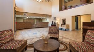a lobby at a hospital with chairs and a table at Best Western Plus Ruidoso Inn in Ruidoso
