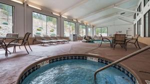 a hot tub in a room with chairs and tables at Best Western Plus Ruidoso Inn in Ruidoso