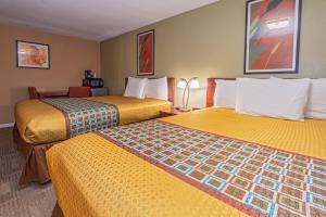 Postel nebo postele na pokoji v ubytování Far West Motel
