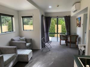 a living room with a couch and a table at Tuscany Gardens Motor Lodge in Nelson