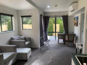 a living room with a couch and a table at Tuscany Gardens Motor Lodge in Nelson