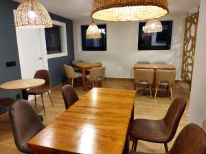 a dining room with tables and chairs and lights at Amillano Rural Suites - Adults only in Amillano