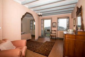 uma sala de estar com um sofá e um quarto em Palazzo Tornielli em Mombello Monferrato