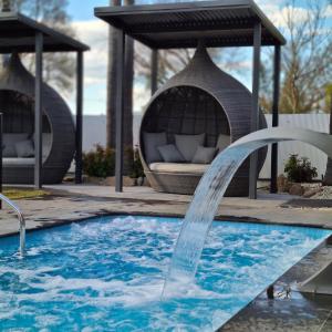 a water fountain in a swimming pool with a gazebo at Federation Motel Resort - Corowa in Corowa