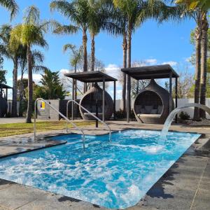 a pool with two water fountains in a park at Federation Motel Resort - Corowa in Corowa