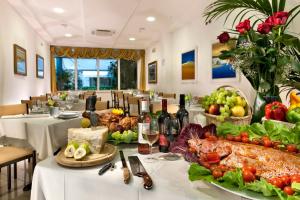 a table with a buffet of food and bottles of wine at Hotel Lina in Misano Adriatico