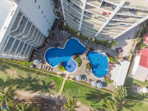 an overhead view of a pool at a resort at Diamante del Sol Ocean front condos, Micasas in Jacó