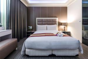 Postel nebo postele na pokoji v ubytování Harmonious Hotel
