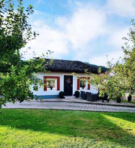 a white and red house with a patio at Ferienhaus Neumann in Kinding