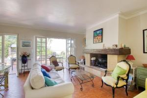 a living room with a couch and a fireplace at Elegant House With Terrace Garden And Pool in Sanary-sur-Mer