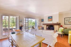 a living room with white furniture and a fireplace at Elegant House With Terrace Garden And Pool in Sanary-sur-Mer