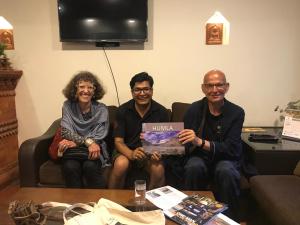 a group of three people sitting on a couch at Hotel vintage Home in Bhaktapur