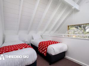 two beds in a room with a white roof at Granite Peaks 4 in Thredbo