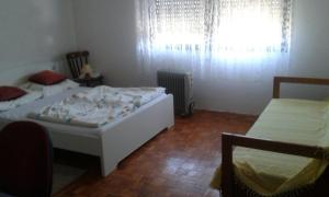 a bedroom with two beds and a window at Apartman Brazil in Bihać +3 photos