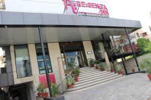 a building with potted plants in front of it at Regenta Inn Jaipur, Adarsh Nagar in Jaipur