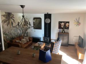 a living room with a couch and a table at La petite maison dans la jungle in Chartres-de-Bretagne