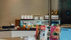 a counter with magazines on a table in a restaurant at LOTTE City Hotel Gimpo Airport in Seoul