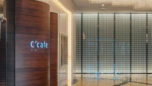 a lobby with a c cafe sign on the wall at LOTTE City Hotel Gimpo Airport in Seoul