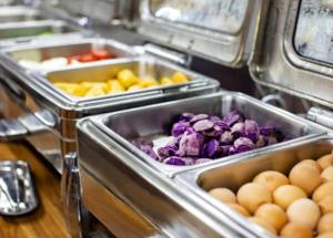 a buffet with several trays of vegetables and eggs at GreenTree Inn Beijing Xicheng District Caishikou Express Hotel in Beijing