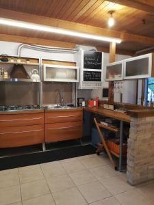 a kitchen with stainless steel appliances in a kitchen at LA BAITA DEL CONTE in San Massimo +26 photos