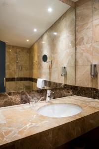 a bathroom with a sink and a shower at Hôtel Saint Germain in Paris