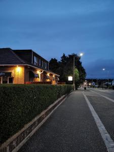 un edificio en una calle por la noche con un semáforo en Glenfern Guest House and a separate Cottage with its own private hot tub, en Balloch