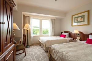 Ένα ή περισσότερα κρεβάτια σε δωμάτιο στο Sendai Royal Park Hotel