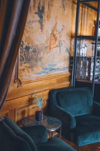 a living room with two chairs and a table at Clarion Grand Hotel in Helsingborg