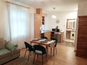 a kitchen and living room with a table and chairs at Ontic Wellness Apartments in Tartu