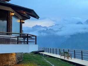 a building with a balcony with a view of the mountains at Casa Himalaya, Auli in Joshīmath