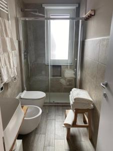 a bathroom with a shower and a toilet and a sink at Casa Stefy in Bari