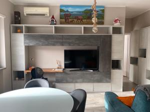 a living room with a tv and a couch and a table at Casa Stefy in Bari